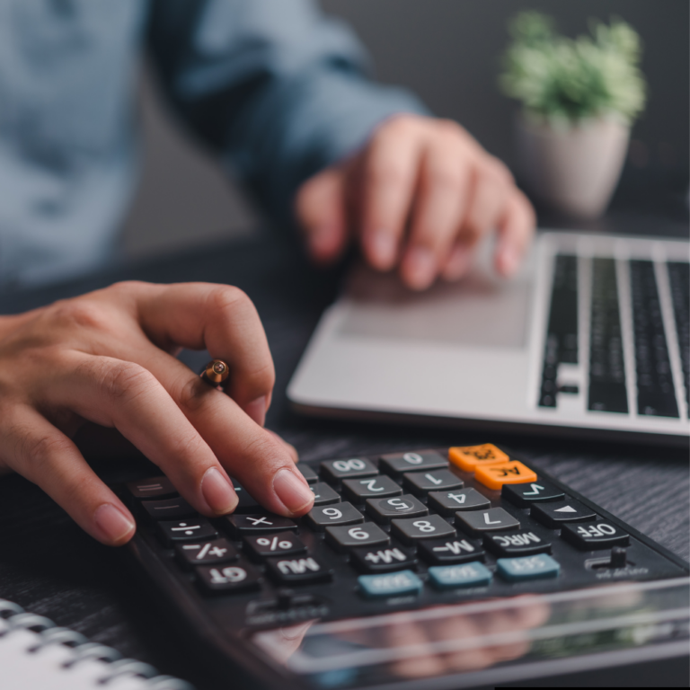 Man using calculator representing using BTU calculator for bathroom radiators