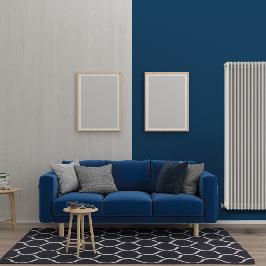 A blue sofa and a white radiator are placed in a bright, inviting room.